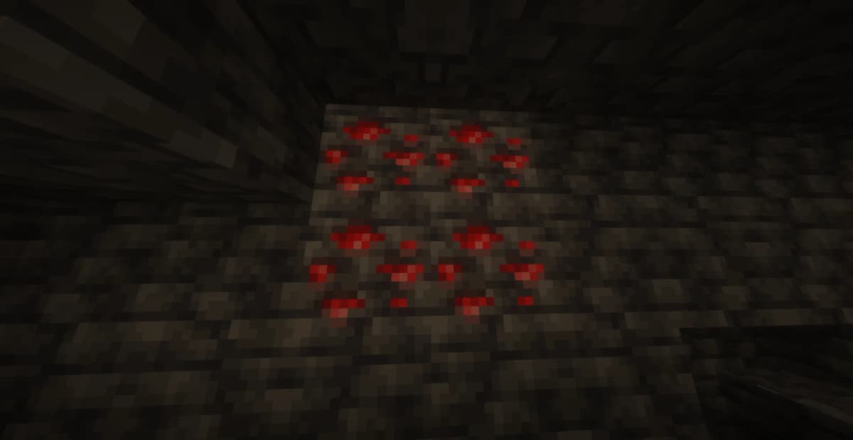 Redstone drops when mining Redstone Ore, which is found in deep underground layers, most commonly at heights Y = -64 to 16.